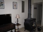 Satellite TV and wood stove are located in the living room.